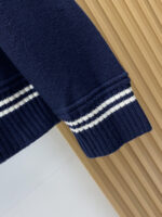 Prada wool blend knit sweater1. Wool and cashmere blended fabric:Selected high-quality wool and cashmere raw materials are blended in a certain proportion. Wool provides warmth and durability, while cashmere gives clothing a soft and delicate touch, making the fabric both comfortable and practical. Different from market products, our sweaters have a softer and more sticky texture2. Yarn preparationYarn dyeing and binding: Analyze the binding of yarn in the original version to ensure color reproduction and good color fastness.Yarn quality inspection: Conduct strict quality inspections on the yarn, including indicators such as line density, evenness, and moisture regain, to ensure that the yarn quality meets production standards.3. Knitted knittingUsing advanced knitting and weaving equipment to weave blended yarn into knitted shirts. During the weaving process, it is necessary to precisely control parameters such as knitting density and pattern changes to ensure the quality and appearance of the finished product. The precision of restoring the knight pattern4. Detail decoration and logo treatmentRibbed Knitted Decoration: Ribbed knitted decoration is used on the collar, cuffs, and hem of knitted shirts to enhance the beauty of details and make the clothing more in line with the body shape.Logo processing: Fix the Equestrian Knight logo (EKD) and Burberry lettering logo onto a knitted sweater through knitting. These logos enhance the recognition of clothing.5. Post sorting and inspectionShrinking treatment: Using the shrinking characteristics of cashmere fibers to shrink knitted sweaters.Ironing and shaping: Ironing knitwear to make it flatter, firmer, and maintain its style characteristics. Accurate temperature and pressure control is required during the ironing process to prevent clothing deformation or damage.Size: M-xxl - Image 6