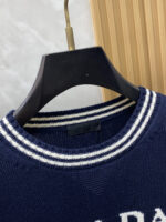 Prada wool blend knit sweater1. Wool and cashmere blended fabric:Selected high-quality wool and cashmere raw materials are blended in a certain proportion. Wool provides warmth and durability, while cashmere gives clothing a soft and delicate touch, making the fabric both comfortable and practical. Different from market products, our sweaters have a softer and more sticky texture2. Yarn preparationYarn dyeing and binding: Analyze the binding of yarn in the original version to ensure color reproduction and good color fastness.Yarn quality inspection: Conduct strict quality inspections on the yarn, including indicators such as line density, evenness, and moisture regain, to ensure that the yarn quality meets production standards.3. Knitted knittingUsing advanced knitting and weaving equipment to weave blended yarn into knitted shirts. During the weaving process, it is necessary to precisely control parameters such as knitting density and pattern changes to ensure the quality and appearance of the finished product. The precision of restoring the knight pattern4. Detail decoration and logo treatmentRibbed Knitted Decoration: Ribbed knitted decoration is used on the collar, cuffs, and hem of knitted shirts to enhance the beauty of details and make the clothing more in line with the body shape.Logo processing: Fix the Equestrian Knight logo (EKD) and Burberry lettering logo onto a knitted sweater through knitting. These logos enhance the recognition of clothing.5. Post sorting and inspectionShrinking treatment: Using the shrinking characteristics of cashmere fibers to shrink knitted sweaters.Ironing and shaping: Ironing knitwear to make it flatter, firmer, and maintain its style characteristics. Accurate temperature and pressure control is required during the ironing process to prevent clothing deformation or damage.Size: M-xxl - Image 3
