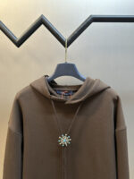 Louis Vuitton Sunflower Hoodie: A Dazzling Fashion Statement
This Louis Vuitton sunflower hoodie is a true showstopper. The front is adorned with dazzling beadwork that intricately carves out Morgan - style floral motifs, resembling precious gems. It also incorporates a bolo - tie - inspired design, paired with a warm and sophisticated Tindal coffee - colored palette.

The embroidery is a masterpiece in itself. It features imported machine - embroidered phoenix eyes. Utilizing an advanced computer - controlled system and precision mechanical components, the embroidery boasts high accuracy, with smooth and delicate lines that add an extra layer of refinement.

Available in sizes S - XXL, this hoodie is a must - have for those who want to make a bold and stylish statement. - Image 9