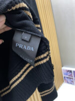 Prada wool blend knit sweater1. Wool and cashmere blended fabric:Selected high-quality wool and cashmere raw materials are blended in a certain proportion. Wool provides warmth and durability, while cashmere gives clothing a soft and delicate touch, making the fabric both comfortable and practical. Different from market products, our sweaters have a softer and more sticky texture2. Yarn preparationYarn dyeing and binding: Analyze the binding of yarn in the original version to ensure color reproduction and good color fastness.Yarn quality inspection: Conduct strict quality inspections on the yarn, including indicators such as line density, evenness, and moisture regain, to ensure that the yarn quality meets production standards.3. Knitted knittingUsing advanced knitting and weaving equipment to weave blended yarn into knitted shirts. During the weaving process, it is necessary to precisely control parameters such as knitting density and pattern changes to ensure the quality and appearance of the finished product. The precision of restoring the knight pattern4. Detail decoration and logo treatmentRibbed Knitted Decoration: Ribbed knitted decoration is used on the collar, cuffs, and hem of knitted shirts to enhance the beauty of details and make the clothing more in line with the body shape.Logo processing: Fix the Equestrian Knight logo (EKD) and Burberry lettering logo onto a knitted sweater through knitting. These logos enhance the recognition of clothing.5. Post sorting and inspectionShrinking treatment: Using the shrinking characteristics of cashmere fibers to shrink knitted sweaters.Ironing and shaping: Ironing knitwear to make it flatter, firmer, and maintain its style characteristics. Accurate temperature and pressure control is required during the ironing process to prevent clothing deformation or damage.Size: M-xxl - Image 7