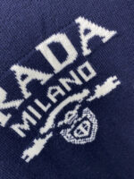 Prada wool blend knit sweater1. Wool and cashmere blended fabric:Selected high-quality wool and cashmere raw materials are blended in a certain proportion. Wool provides warmth and durability, while cashmere gives clothing a soft and delicate touch, making the fabric both comfortable and practical. Different from market products, our sweaters have a softer and more sticky texture2. Yarn preparationYarn dyeing and binding: Analyze the binding of yarn in the original version to ensure color reproduction and good color fastness.Yarn quality inspection: Conduct strict quality inspections on the yarn, including indicators such as line density, evenness, and moisture regain, to ensure that the yarn quality meets production standards.3. Knitted knittingUsing advanced knitting and weaving equipment to weave blended yarn into knitted shirts. During the weaving process, it is necessary to precisely control parameters such as knitting density and pattern changes to ensure the quality and appearance of the finished product. The precision of restoring the knight pattern4. Detail decoration and logo treatmentRibbed Knitted Decoration: Ribbed knitted decoration is used on the collar, cuffs, and hem of knitted shirts to enhance the beauty of details and make the clothing more in line with the body shape.Logo processing: Fix the Equestrian Knight logo (EKD) and Burberry lettering logo onto a knitted sweater through knitting. These logos enhance the recognition of clothing.5. Post sorting and inspectionShrinking treatment: Using the shrinking characteristics of cashmere fibers to shrink knitted sweaters.Ironing and shaping: Ironing knitwear to make it flatter, firmer, and maintain its style characteristics. Accurate temperature and pressure control is required during the ironing process to prevent clothing deformation or damage.Size: M-xxl - Image 5