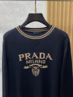 Prada wool blend knit sweater1. Wool and cashmere blended fabric:Selected high-quality wool and cashmere raw materials are blended in a certain proportion. Wool provides warmth and durability, while cashmere gives clothing a soft and delicate touch, making the fabric both comfortable and practical. Different from market products, our sweaters have a softer and more sticky texture2. Yarn preparationYarn dyeing and binding: Analyze the binding of yarn in the original version to ensure color reproduction and good color fastness.Yarn quality inspection: Conduct strict quality inspections on the yarn, including indicators such as line density, evenness, and moisture regain, to ensure that the yarn quality meets production standards.3. Knitted knittingUsing advanced knitting and weaving equipment to weave blended yarn into knitted shirts. During the weaving process, it is necessary to precisely control parameters such as knitting density and pattern changes to ensure the quality and appearance of the finished product. The precision of restoring the knight pattern4. Detail decoration and logo treatmentRibbed Knitted Decoration: Ribbed knitted decoration is used on the collar, cuffs, and hem of knitted shirts to enhance the beauty of details and make the clothing more in line with the body shape.Logo processing: Fix the Equestrian Knight logo (EKD) and Burberry lettering logo onto a knitted sweater through knitting. These logos enhance the recognition of clothing.5. Post sorting and inspectionShrinking treatment: Using the shrinking characteristics of cashmere fibers to shrink knitted sweaters.Ironing and shaping: Ironing knitwear to make it flatter, firmer, and maintain its style characteristics. Accurate temperature and pressure control is required during the ironing process to prevent clothing deformation or damage.Size: M-xxl - Image 2