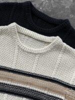 🆕- This knitted sweater weaves a Mediterranean breeze into the wardrobeWhen 10 cotton yarns and 46 blended yarns meet on a seven needle jacquard machine, the three yarns begin to weave a dialogue about material and color. Navy blue and navy blue cotton yarn have a rough and rustic feel, like the late night waters of the Adriatic Sea; The addition of 3.7% mulberry silk and wool in the light camel colored blended yarn gives the striped edges a subtle luster, reminiscent of the sparkling waves at sunset in Venice.When the weight of 580 grams is unfolded in the hand, one can feel the delicate balance between the stiffness of cotton and the softness of blended yarn. The vertical jacquard woven alternately with osmanthus needles and hanging needles forms a subtle texture on the navy blue background, resembling the outline of Venetian architecture seen through blinds. The white version is like a linen cloth sprinkled with sunlight, and the collision of the three materials is portrayed more clearly on a pure white canvas.The curvature of the round neck continues the elegant tradition of Italian tailoring, neither tightening the neck nor maintaining sharp lines. The contraction process of the hem keeps the hem of the garment firmly attached to the waist, and it will not move up whether you lift your hand or turn around. To support the muscles and bones with 10 strands of cotton yarn, to outline with delicate 46 strands of blended yarn, and to add luster and mulberry silk embellishment - this knitted sweater weaves the advantages of different materials into the same picture.The navy blue version paired with white pants is a classic Mediterranean style, while the white version paired with dark gray trousers can instantly switch to Milan style urban elegance. The intentions hidden in the texture of osmanthus needles, yarn blending, and precise weight all need to be personally felt in the cool autumn breeze to fully understand. While others are still struggling with the basic knitwear, this three layered jacquard sweater has already captivated the eyes of those who understand it with its sense of layering.In the current era of fast fashion proliferation, a blend knit that becomes softer and skin friendly with increasing wear is the truly worthwhile wardrobe evergreen tree to invest in. Jay Ya uses this piece to prove that a sophisticated sense of leisure allows every material to find the most comfortable expression in fabric.Color: White navy blue174-140 upper body size LSize: M-XXXL (48-56)Style number: FXZZ8688M size bust circumference 104 shoulder width 46.5 sleeve length 56 garment length 64.5Size L Chest circumference 108 Shoulder width 48 Sleeve length 57 Clothing length 66XL bust circumference 112 shoulder width 49.5 sleeve length 58 garment length 67.5XXL chest circumference 116 shoulder width 51 sleeve length 59 garment length 68.5XXXL bust circumference 120 shoulder width 52.5 sleeve length 60 garment length 69.5 - Image 7
