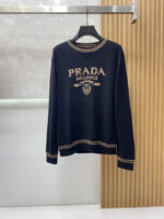 Prada wool blend knit sweater1. Wool and cashmere blended fabric:Selected high-quality wool and cashmere raw materials are blended in a certain proportion. Wool provides warmth and durability, while cashmere gives clothing a soft and delicate touch, making the fabric both comfortable and practical. Different from market products, our sweaters have a softer and more sticky texture2. Yarn preparationYarn dyeing and binding: Analyze the binding of yarn in the original version to ensure color reproduction and good color fastness.Yarn quality inspection: Conduct strict quality inspections on the yarn, including indicators such as line density, evenness, and moisture regain, to ensure that the yarn quality meets production standards.3. Knitted knittingUsing advanced knitting and weaving equipment to weave blended yarn into knitted shirts. During the weaving process, it is necessary to precisely control parameters such as knitting density and pattern changes to ensure the quality and appearance of the finished product. The precision of restoring the knight pattern4. Detail decoration and logo treatmentRibbed Knitted Decoration: Ribbed knitted decoration is used on the collar, cuffs, and hem of knitted shirts to enhance the beauty of details and make the clothing more in line with the body shape.Logo processing: Fix the Equestrian Knight logo (EKD) and Burberry lettering logo onto a knitted sweater through knitting. These logos enhance the recognition of clothing.5. Post sorting and inspectionShrinking treatment: Using the shrinking characteristics of cashmere fibers to shrink knitted sweaters.Ironing and shaping: Ironing knitwear to make it flatter, firmer, and maintain its style characteristics. Accurate temperature and pressure control is required during the ironing process to prevent clothing deformation or damage.Size: M-xxl