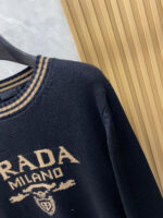 Prada wool blend knit sweater1. Wool and cashmere blended fabric:Selected high-quality wool and cashmere raw materials are blended in a certain proportion. Wool provides warmth and durability, while cashmere gives clothing a soft and delicate touch, making the fabric both comfortable and practical. Different from market products, our sweaters have a softer and more sticky texture2. Yarn preparationYarn dyeing and binding: Analyze the binding of yarn in the original version to ensure color reproduction and good color fastness.Yarn quality inspection: Conduct strict quality inspections on the yarn, including indicators such as line density, evenness, and moisture regain, to ensure that the yarn quality meets production standards.3. Knitted knittingUsing advanced knitting and weaving equipment to weave blended yarn into knitted shirts. During the weaving process, it is necessary to precisely control parameters such as knitting density and pattern changes to ensure the quality and appearance of the finished product. The precision of restoring the knight pattern4. Detail decoration and logo treatmentRibbed Knitted Decoration: Ribbed knitted decoration is used on the collar, cuffs, and hem of knitted shirts to enhance the beauty of details and make the clothing more in line with the body shape.Logo processing: Fix the Equestrian Knight logo (EKD) and Burberry lettering logo onto a knitted sweater through knitting. These logos enhance the recognition of clothing.5. Post sorting and inspectionShrinking treatment: Using the shrinking characteristics of cashmere fibers to shrink knitted sweaters.Ironing and shaping: Ironing knitwear to make it flatter, firmer, and maintain its style characteristics. Accurate temperature and pressure control is required during the ironing process to prevent clothing deformation or damage.Size: M-xxl - Image 4