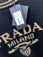 Prada wool blend knit sweater1. Wool and cashmere blended fabric:Selected high-quality wool and cashmere raw materials are blended in a certain proportion. Wool provides warmth and durability, while cashmere gives clothing a soft and delicate touch, making the fabric both comfortable and practical. Different from market products, our sweaters have a softer and more sticky texture2. Yarn preparationYarn dyeing and binding: Analyze the binding of yarn in the original version to ensure color reproduction and good color fastness.Yarn quality inspection: Conduct strict quality inspections on the yarn, including indicators such as line density, evenness, and moisture regain, to ensure that the yarn quality meets production standards.3. Knitted knittingUsing advanced knitting and weaving equipment to weave blended yarn into knitted shirts. During the weaving process, it is necessary to precisely control parameters such as knitting density and pattern changes to ensure the quality and appearance of the finished product. The precision of restoring the knight pattern4. Detail decoration and logo treatmentRibbed Knitted Decoration: Ribbed knitted decoration is used on the collar, cuffs, and hem of knitted shirts to enhance the beauty of details and make the clothing more in line with the body shape.Logo processing: Fix the Equestrian Knight logo (EKD) and Burberry lettering logo onto a knitted sweater through knitting. These logos enhance the recognition of clothing.5. Post sorting and inspectionShrinking treatment: Using the shrinking characteristics of cashmere fibers to shrink knitted sweaters.Ironing and shaping: Ironing knitwear to make it flatter, firmer, and maintain its style characteristics. Accurate temperature and pressure control is required during the ironing process to prevent clothing deformation or damage.Size: M-xxl - Image 5