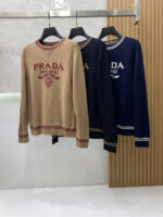Prada wool blend knit sweater1. Wool and cashmere blended fabric:Selected high-quality wool and cashmere raw materials are blended in a certain proportion. Wool provides warmth and durability, while cashmere gives clothing a soft and delicate touch, making the fabric both comfortable and practical. Different from market products, our sweaters have a softer and more sticky texture2. Yarn preparationYarn dyeing and binding: Analyze the binding of yarn in the original version to ensure color reproduction and good color fastness.Yarn quality inspection: Conduct strict quality inspections on the yarn, including indicators such as line density, evenness, and moisture regain, to ensure that the yarn quality meets production standards.3. Knitted knittingUsing advanced knitting and weaving equipment to weave blended yarn into knitted shirts. During the weaving process, it is necessary to precisely control parameters such as knitting density and pattern changes to ensure the quality and appearance of the finished product. The precision of restoring the knight pattern4. Detail decoration and logo treatmentRibbed Knitted Decoration: Ribbed knitted decoration is used on the collar, cuffs, and hem of knitted shirts to enhance the beauty of details and make the clothing more in line with the body shape.Logo processing: Fix the Equestrian Knight logo (EKD) and Burberry lettering logo onto a knitted sweater through knitting. These logos enhance the recognition of clothing.5. Post sorting and inspectionShrinking treatment: Using the shrinking characteristics of cashmere fibers to shrink knitted sweaters.Ironing and shaping: Ironing knitwear to make it flatter, firmer, and maintain its style characteristics. Accurate temperature and pressure control is required during the ironing process to prevent clothing deformation or damage.Size: M-xxl - Image 9